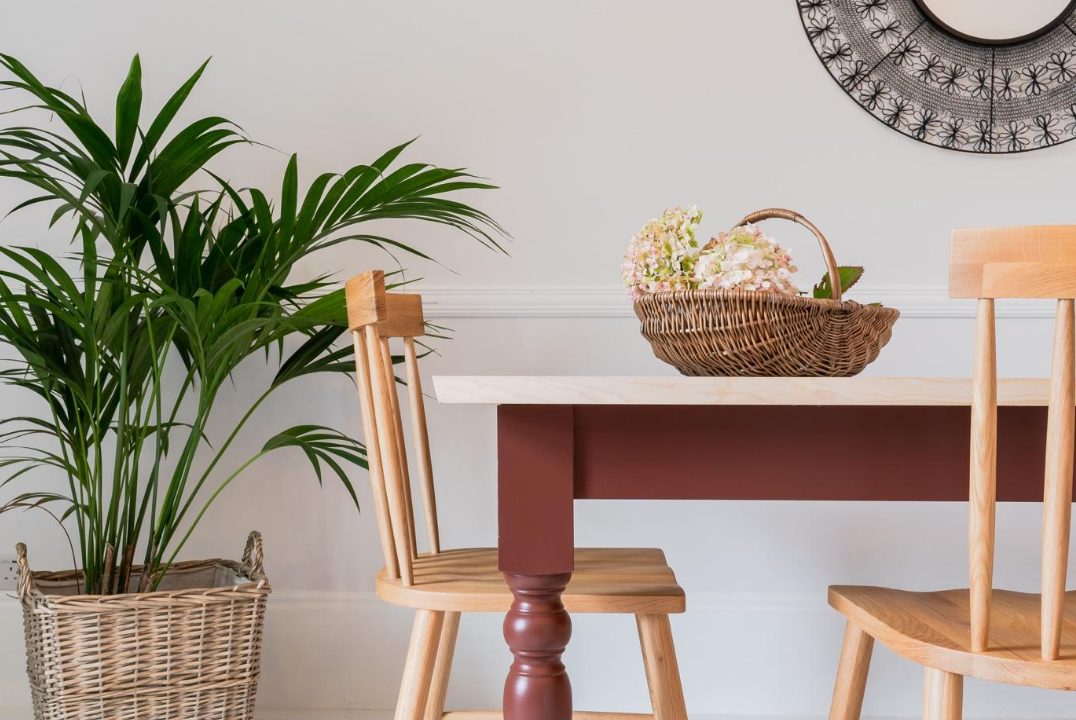 Farmhouse wooden dining table in a dining room. Plum finish