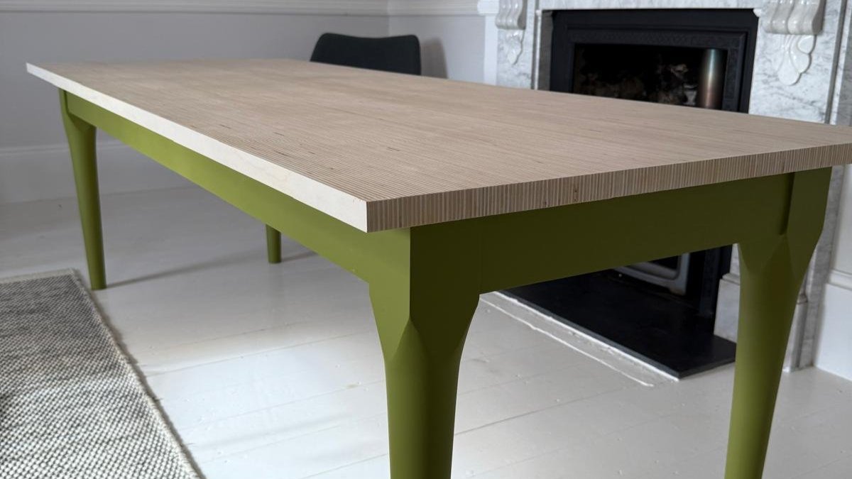 Edge Shape of Wooden Dining Table with green legs. 